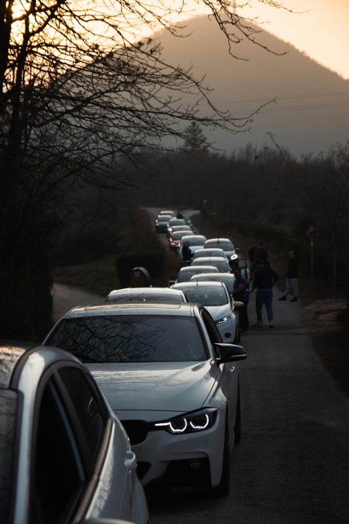 a line of cars parked on the side of a road